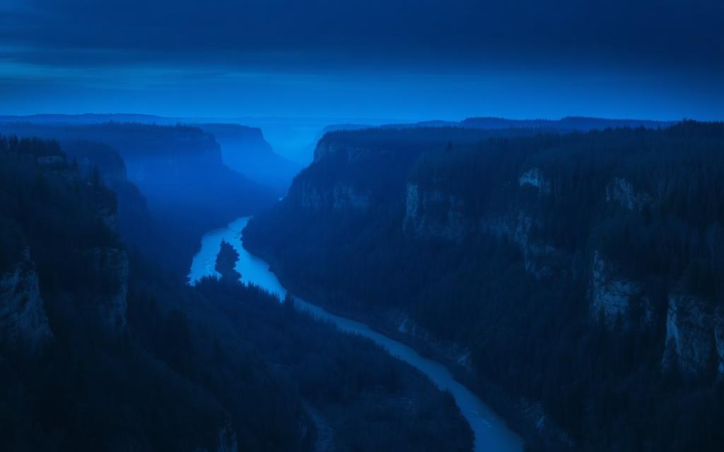 Arkansas — River winding through a forested valley at twilight